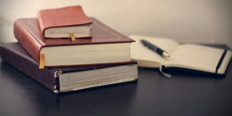 Stacks of law books on a desk