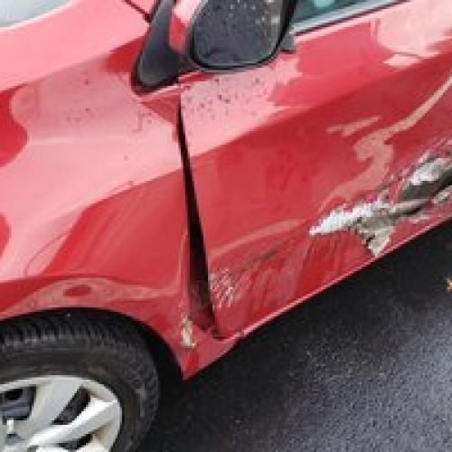 red car with smashed door